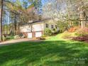 Spacious two-story home with a two-car garage and lush green lawn at 8801 Chinaberry Ln, Concord, NC 28027