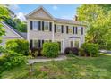 Charming two-story home featuring a well-manicured lawn and classic architectural details at 9100 Cameron Wood Dr, Charlotte, NC 28210