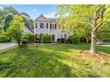 Well-maintained home with mature trees, lush lawn, and classic black shutters at 9100 Cameron Wood Dr, Charlotte, NC 28210