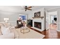 Cozy living room with a fireplace, neutral tones, and view to dining room, creating a warm ambiance at 9941 Heritage Oak Ln, Waxhaw, NC 28173