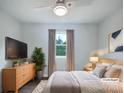 Comfortable bedroom is virtually staged with neutral decor and includes a ceiling fan at 109 Downing St, Troutman, NC 28166