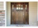 Inviting front door with sidelights, paneled design, and stone accents for added curb appeal at 109 Trent Pines Dr, Mooresville, NC 28117