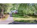 Exterior view of a home with a long driveway, surrounded by lush green trees at 114 Walnut Creek Rd # 24, Belmont, NC 28012