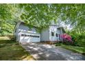 Home featuring a two-car garage and a blossoming pink bush in front of the house at 114 Walnut Creek Rd # 24, Belmont, NC 28012