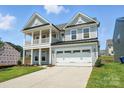 Charming two-story home with a welcoming front porch and attached two-car garage at 119 Longwood Rd # 62, Mooresville, NC 28115