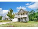 Two-story home with a cozy front porch and well-manicured lawn at 119 Longwood Rd # 62, Mooresville, NC 28115