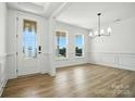Bright foyer with decorative glass door, wood floors, and natural light at 119 Longwood Rd # 62, Mooresville, NC 28115