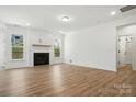 Inviting living room with a shiplap fireplace, wood floors, and lots of natural light at 119 Longwood Rd # 62, Mooresville, NC 28115
