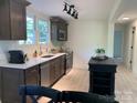 Updated kitchen features stainless appliances, modern countertops, and dark wood cabinets at 188 Bailey Rd, Mooresville, NC 28117
