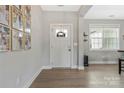 Bright entryway with hardwood floors, a white front door, and decorative wall art, creating a welcoming and stylish foyer at 2119 Smith Rd, Clover, SC 29710