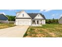 Inviting two-story home featuring a well-maintained lawn, covered porch, and attached garage, showcasing its attractive facade at 2119 Smith Rd, Clover, SC 29710