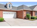 A spacious two-car garage on a red brick home, providing ample parking and storage at 2334 Sylvia Ct, Denver, NC 28037