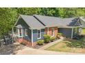 An elevated view showcasing the blue siding and brick accents, highlighting the home's architectural details and landscaping at 2848 Briar Ridge Dr, Charlotte, NC 28270