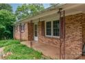 Close-up of a covered front porch featuring brick columns and large windows at 302 Kimberlee Dr, Shelby, NC 28152