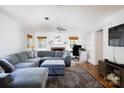 Bright living room featuring a comfortable gray sectional sofa, fireplace, and hardwood floors in a well-lit setting at 311 Airport Rd, Rock Hill, SC 29732