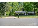 Classic brick home with mature trees, a long driveway, and a traditional mailbox at 438 Starcrest Cir # C, Rock Hill, SC 29730