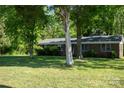 Brick home with a well-manicured lawn and trees providing shade and privacy at 438 Starcrest Cir # C, Rock Hill, SC 29730