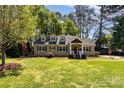 Well-maintained front exterior of this single-Gathering home with mature trees and landscaped front lawn at 4467 Woodlark Ln, Charlotte, NC 28211