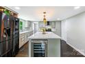Bright, renovated kitchen features modern stainless steel appliances, stone countertops, and a wine fridge at 502 Hyde St, Kannapolis, NC 28083