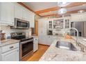 Bright kitchen with stainless steel appliances, granite countertops, and wooden ceiling beams at 5047 Victory Trl, Gastonia, NC 28056