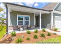 Inviting porch with seating area and lush landscaping at 510 Black Bear St # 145P, China Grove, NC 28023