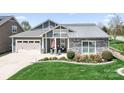 Inviting home featuring a well-manicured lawn, a two-car garage, and stone and siding details at 5103 Looking Glass Trl, Denver, NC 28037