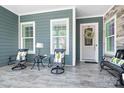 Charming front porch with comfortable seating, stylish decor, and a welcoming entrance at 5103 Looking Glass Trl, Denver, NC 28037
