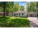 Inviting single story home with attached carport and well-manicured lawn at 5218 Addison Dr, Charlotte, NC 28211