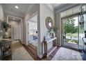 Inviting foyer featuring hardwood floors and a decorative console table with mirror at 7123 Meyer Rd, Fort Mill, SC 29715