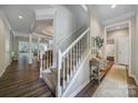 Spacious hallway with staircase, hardwood floors, and views into the living areas at 7123 Meyer Rd, Fort Mill, SC 29715