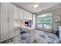 Bright home office featuring built-in cabinetry, a desk, and a large window at 7123 Meyer Rd, Fort Mill, SC 29715