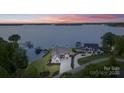 Breathtaking aerial view of a luxurious waterfront estate with private docks at 7679 Rabbit Cir, Denver, NC 28037