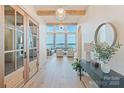 Inviting foyer with hardwood floors, elegant lighting, and scenic waterfront views at 7679 Rabbit Cir, Denver, NC 28037