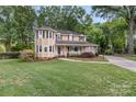Well maintained home with mature lawn, manicured landscaping and covered front porch at 8214 Coristar Pl, Huntersville, NC 28078