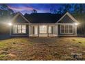 Well-lit home exterior, showcasing the back porch and expansive backyard at 925 Twin Lakes Rd, Rock Hill, SC 29732