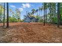 Spacious new construction home with light blue siding and ample yard space surrounded by mature trees at 925 Twin Lakes Rd, Rock Hill, SC 29732