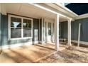 Inviting covered front porch with white columns and trim and craftsman style door with sidelight window at 925 Twin Lakes Rd, Rock Hill, SC 29732