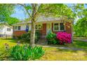 Inviting single-Gathering home with brick facade, blooming flowers, and a well-kept lawn at 105 Hopper St, Clover, SC 29710