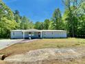 Charming home featuring a concrete driveway, manicured lawn, and light blue siding at 109 Bee Tree Ln, Salisbury, NC 28144