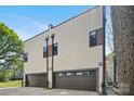 Exterior view of modern home highlighting siding detail and multiple car garage at 1115 Greenleaf Ave # B, Charlotte, NC 28202
