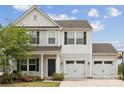 Beautiful two-story home with a spacious two-car garage, covered porch, and manicured lawn at 1218 Juddson Dr, Waxhaw, NC 28173