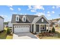 Charming home with a two-car garage, neat landscaping, and a welcoming entrance for an inviting curb appeal at 124 Canary Ln # 7, Mooresville, NC 28115