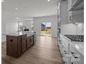 Modern kitchen with a large island, stainless steel appliances, and a view into the living room at 124 Canary Ln # 7, Mooresville, NC 28115
