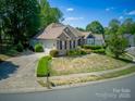 Beautiful brick home featuring a well-manicured lawn and a two-car garage at 13316 Alex Mill Dr, Pineville, NC 28134