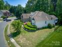 Exterior view of a well-maintained home showing the backyard and landscaping at 13316 Alex Mill Dr, Pineville, NC 28134