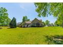 Expansive backyard with lush green lawn, mature trees, and plenty of space for outdoor activities at 1374 Weatherby Dr, Salisbury, NC 28146