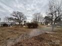 View of expansive yard featuring mature trees, shrubs, and bare lawn at 14131 Lucia Riverbend Hwy, Mount Holly, NC 28120