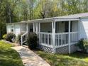 Inviting covered front porch with white railings and lattice accents at 143 Ezra Rd, Kings Mountain, NC 28086
