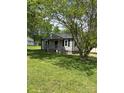 Cozy home with a charming front porch surrounded by lush greenery at 155 Ervin Loop, China Grove, NC 28023