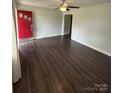 Spacious living room with dark wood flooring and a bright red entry door at 155 Ervin Loop, China Grove, NC 28023